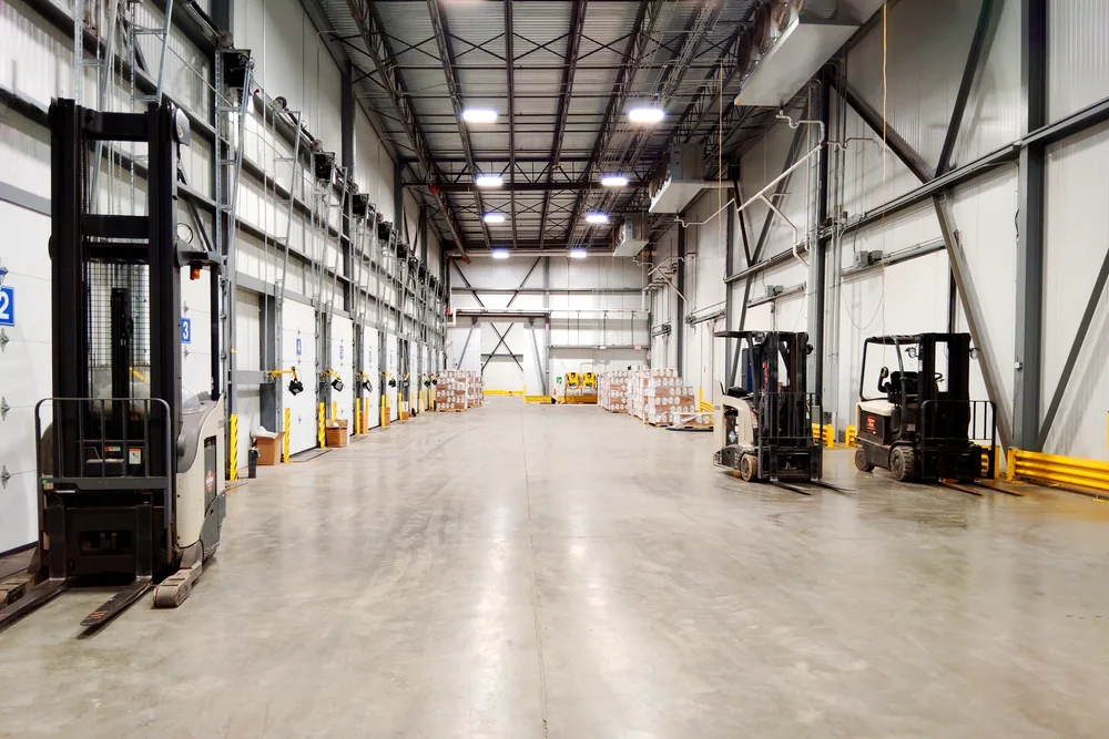 The refrigerated dock inside the Louisville facility, with numbered dock doors down one side and forklifts on the floor