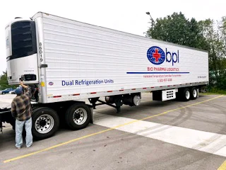 A Bio Pharma Logistics refrigerated storage trailer staged in a lot, its reefer unit running and its livery reading Dual Refrigeration Units
