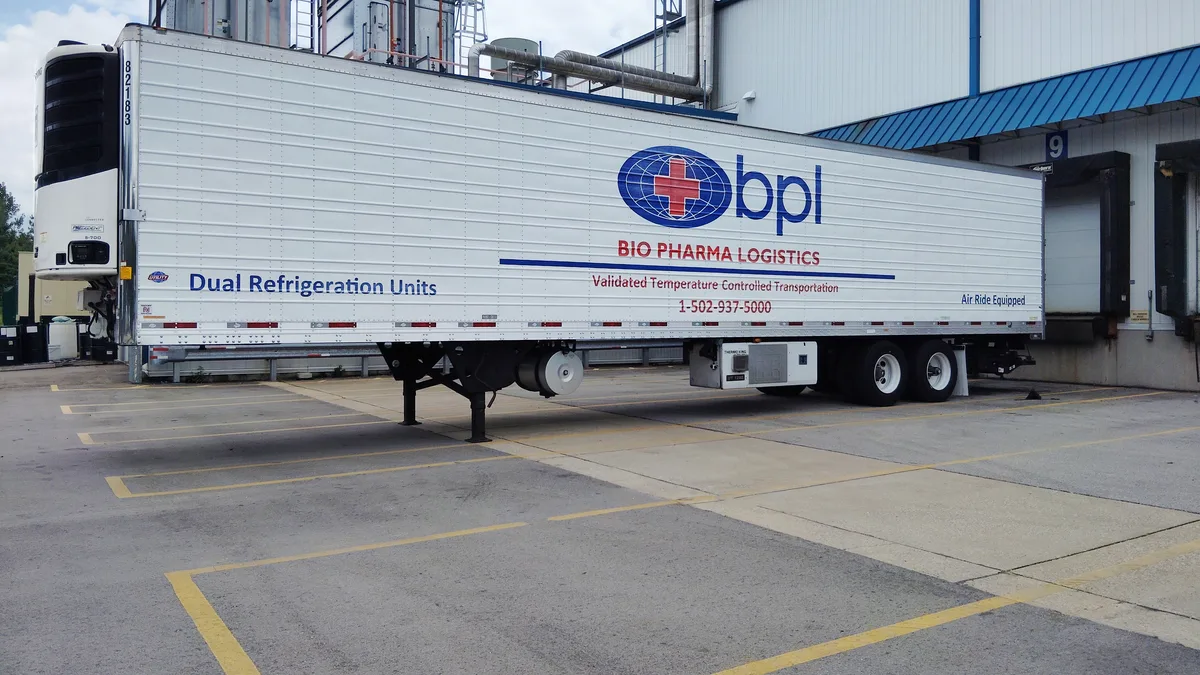 A Bio Pharma Logistics refrigerated trailer alongside the Louisville dock, its livery reading Dual Refrigeration Units and Validated Temperature Controlled Transportation